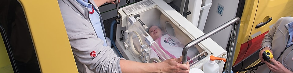 lady operating machine with baby in it