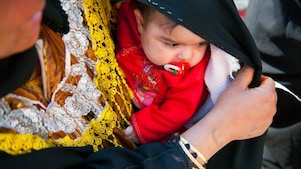 Gyermekét magához ölelő szülő