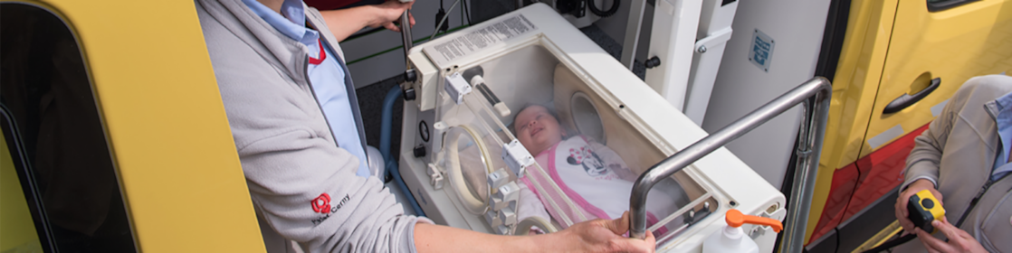 lady operating machine with baby in it
