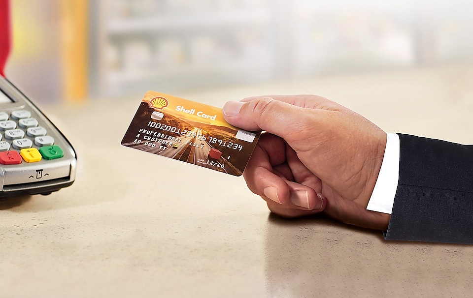 A man holding a Shell card