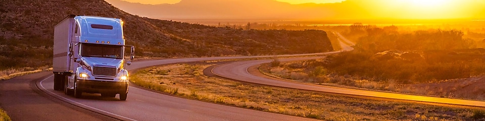 18-wheeler on interstate highway at sunset