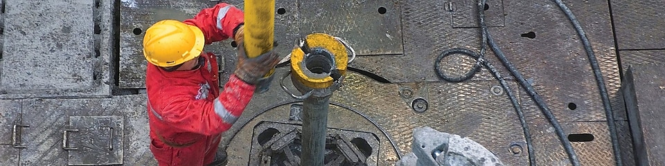 Man drilling in a rig
