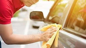 A person cleaning a car