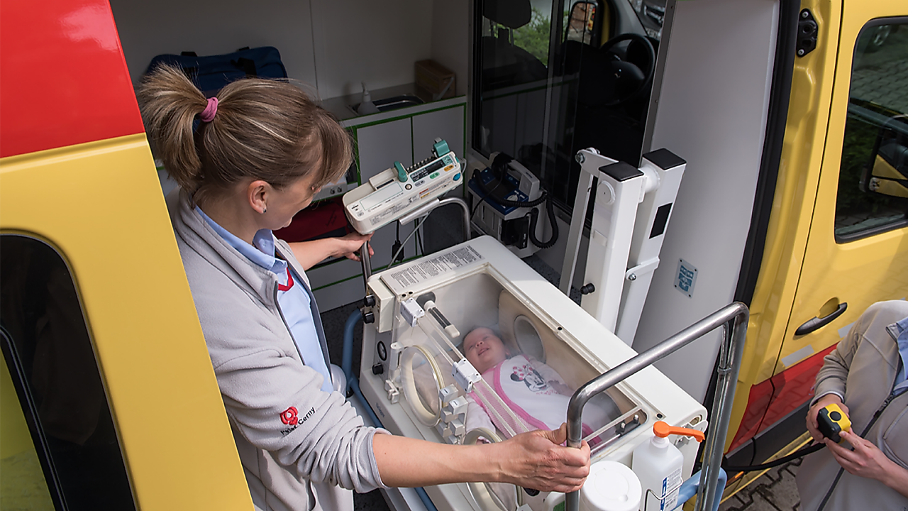 lady operating machine with baby in it