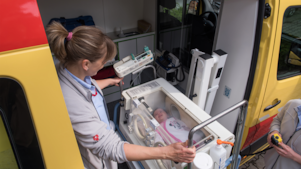 lady operating machine with baby in it